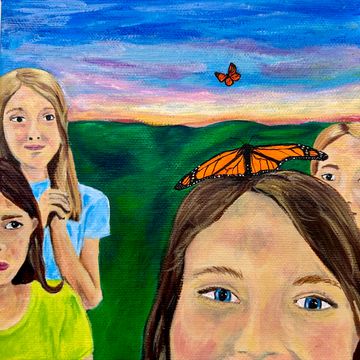 A girl with a Monarch butterfly on her head surrounded by other girls looking in awe and joy. 