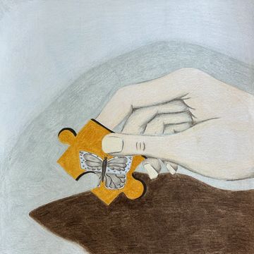 A hand turning over a puzzle piece to reveal a butterfly. 