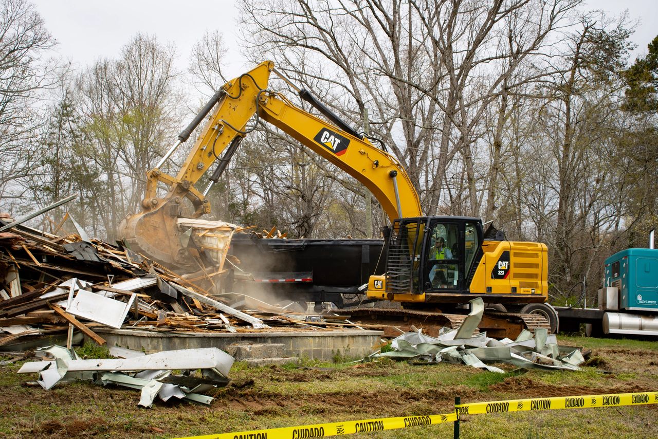 A bulldozer taking down Donald Surratt's home. Tuesday, March 26, 2024, by Mason Beam (WNN).