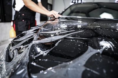 Luxury car receiving PPF in Troy, MI. Mobile paint protection film for lasting durability.
