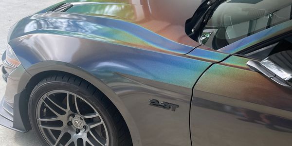 Car getting a full vinyl wrap in carbon fiber in Livonia, MI. Stylish mobile wrap service near you.