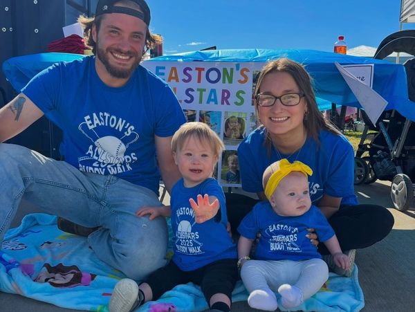 Family in matching blue shirts at Easton's Allstars Buddy Walk event.