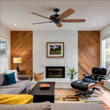 Cozy modern living room with wood accents and black lounge chair.