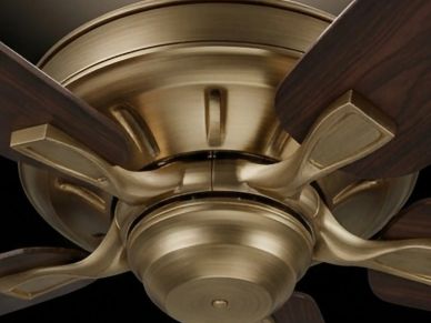 Close-up of a ceiling fan's motor housing and blade arms.
