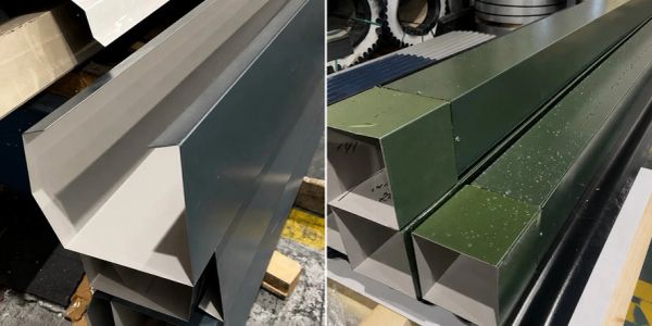 Stacked metal beams with different colors in an industrial setting.