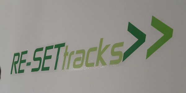 RE-SETtracks logo. Which spells out Resistance Equipment Stretch Exercise Therapy tracks