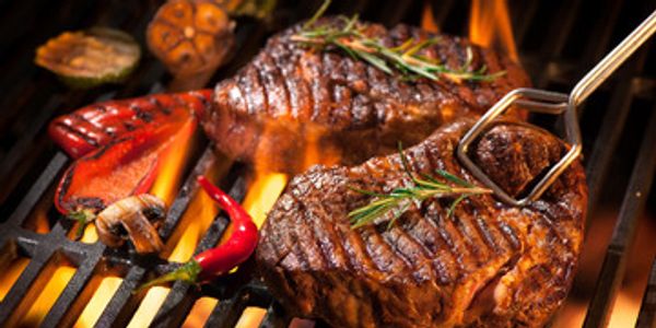 Steak being grilled on a BBQ