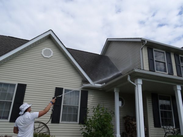 Hydro Restorations cleaning a vinyl house 