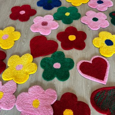 Colorful flower and heart-shaped rugs on the floor.