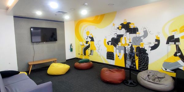 Cozy lounge with bean bags and a vibrant mural on the wall.