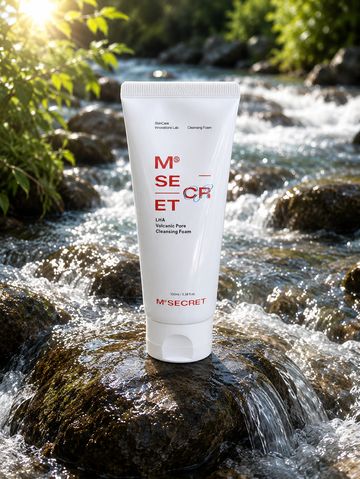 A skincare cleansing foam tube placed on a wet rock in a flowing stream.