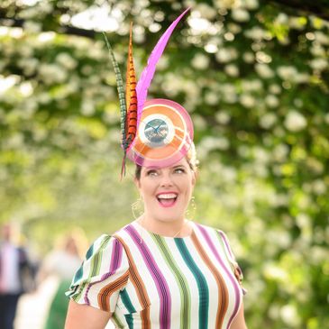 Peacock Millinery client enjoying her custom headwear and having a millinery moment.