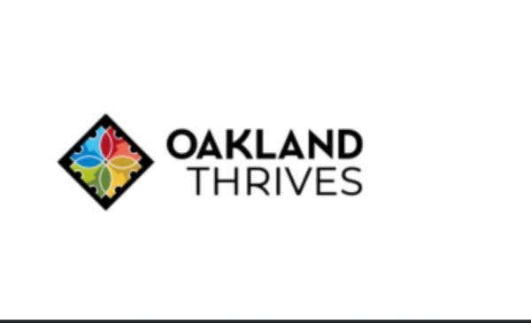 Oakland Thrives logo featuring colorful petals.