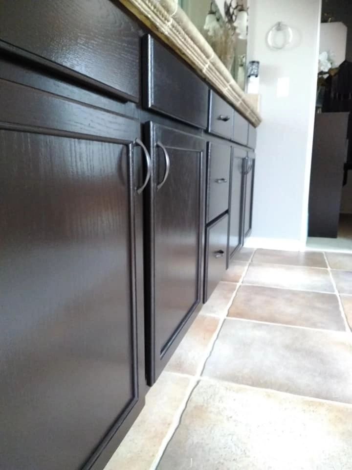 The herringbone floors are gray/white. dark chocolate brown bathroom