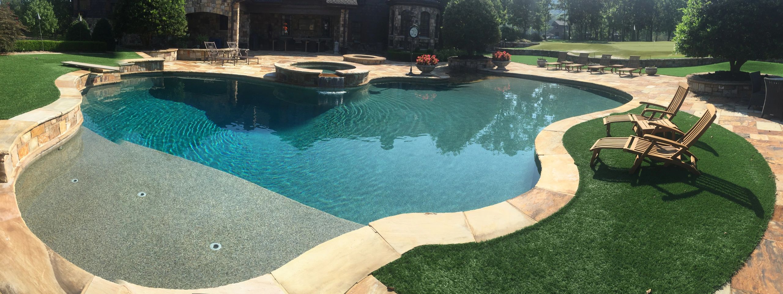 pool with tanning ledge water fall and hot tub
