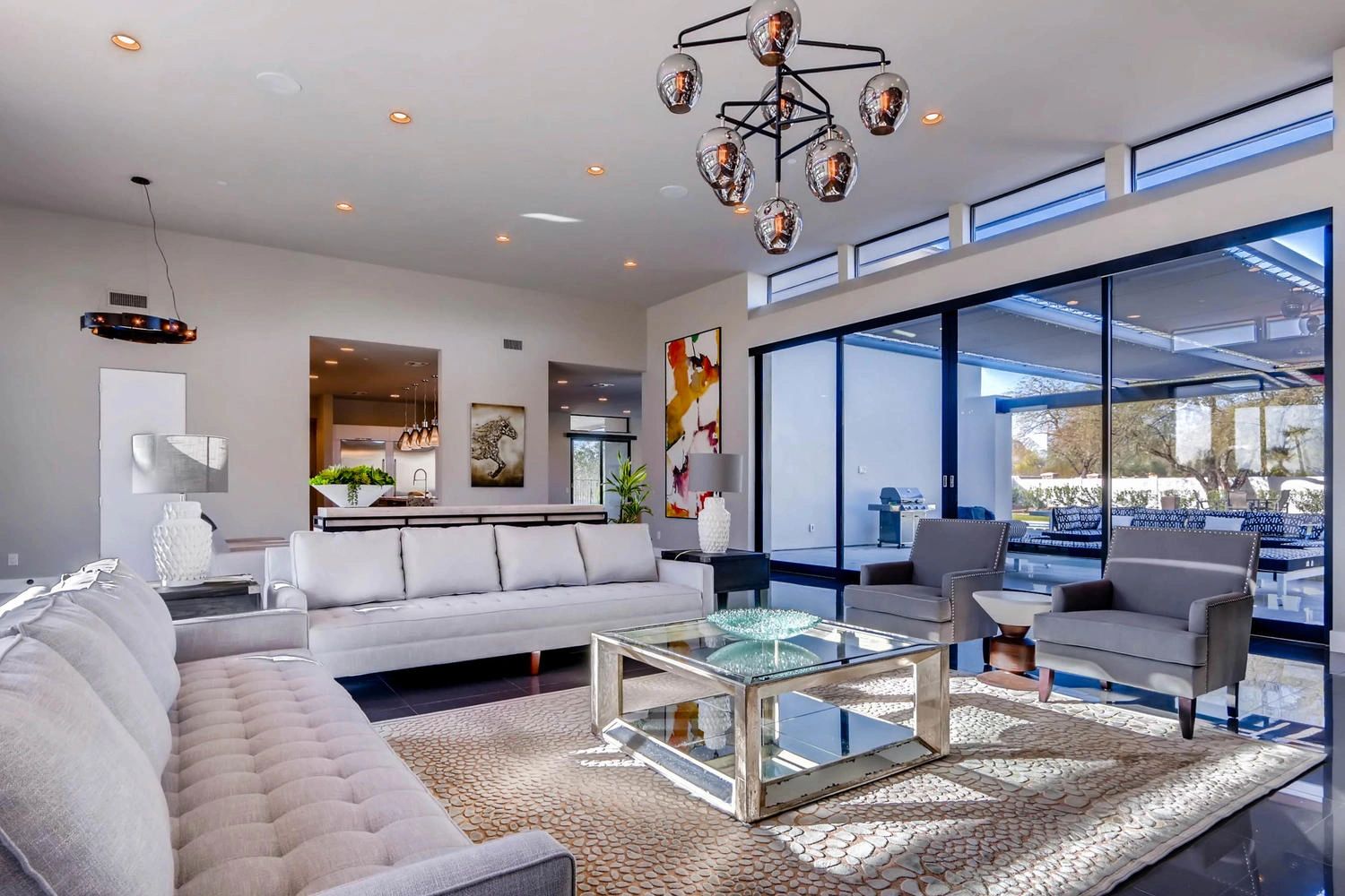 Modern living room with large windows and stylish furniture.