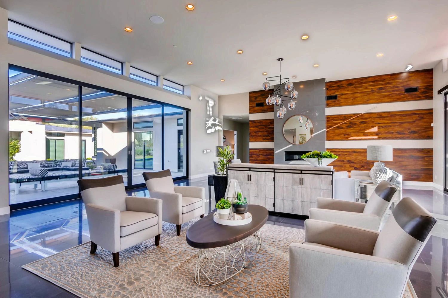 Modern living room with beige chairs and a stylish wooden accent wall.