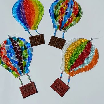 Colorful glass hot air balloon ornaments with intricate patterns.