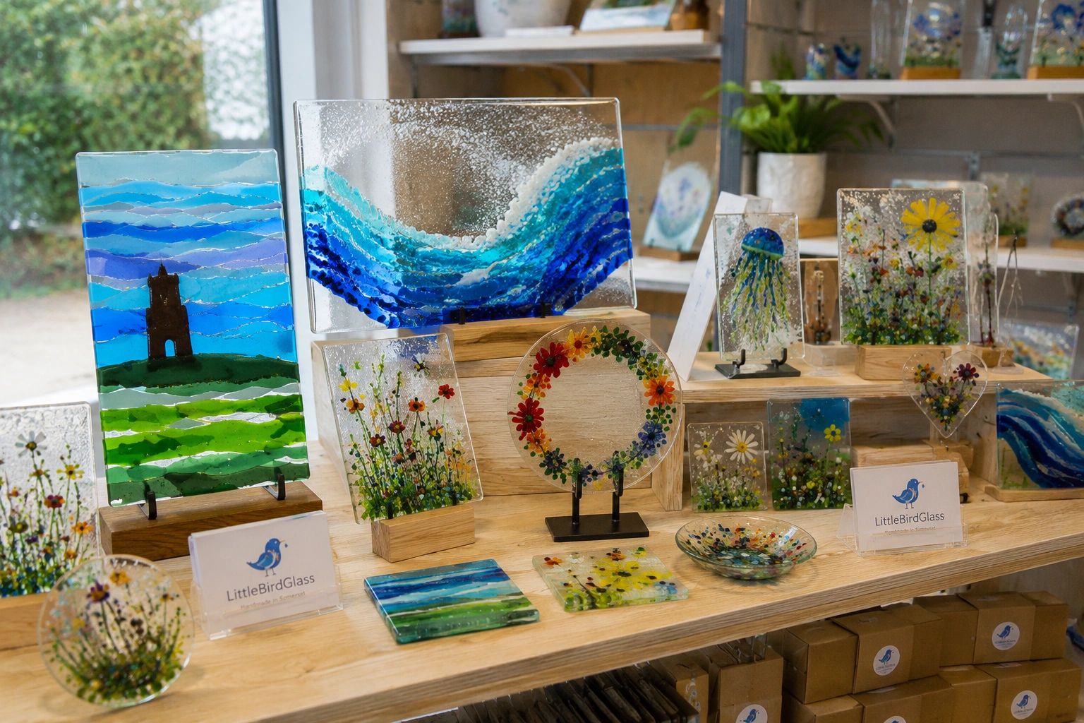 Handmade fused glass art pieces on display.
