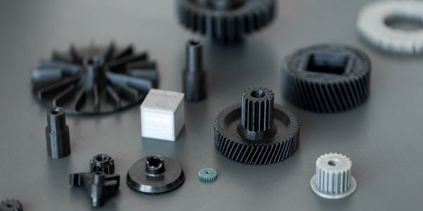 Various plastic gears and mechanical parts arranged on a surface.