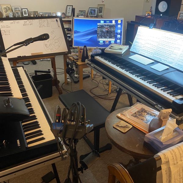 Music studio setup with keyboards and microphone.