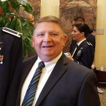 Smiling man in suit at formal event.