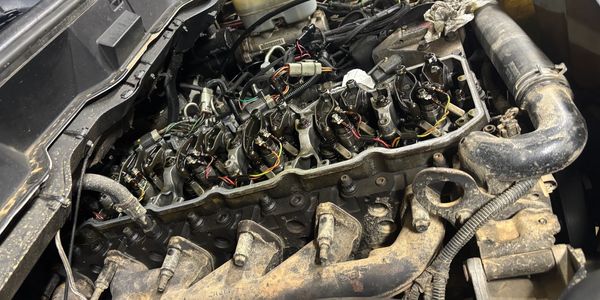 Car engine with exposed components and wiring.