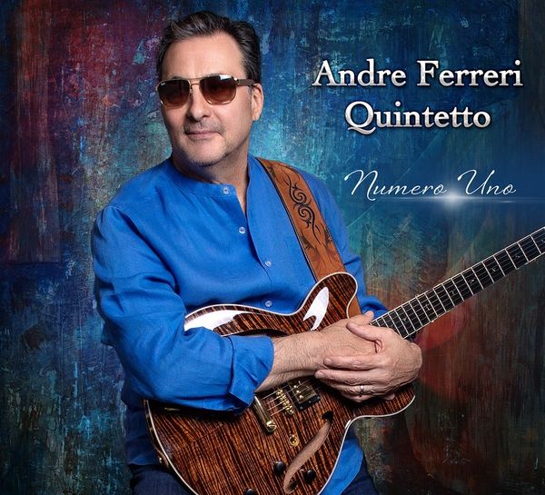 Andre Ferreri in blue shirt with guitar, promoting Numero Uno album.