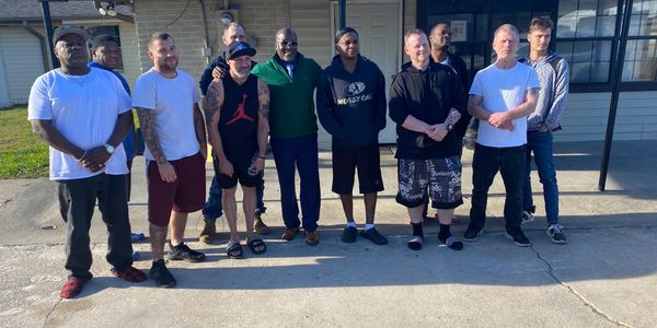 A group of friends standing On the road and looking on the camera