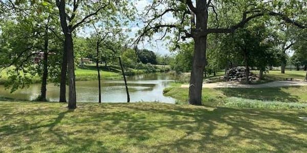 Johnson Park in Marble Falls, Texas, with mature trees, green space and peaceful waterfront scenery.