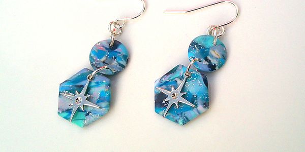Blue marbled dangle handmade earrings with silver star charms.