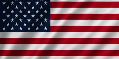The flag of the United States with stars and stripes waving.