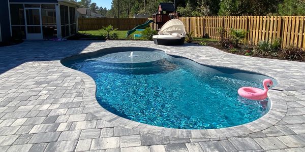 Sun Drenched Pools installation of a San Juan Fiberglass Pool granite Huntington Beach model