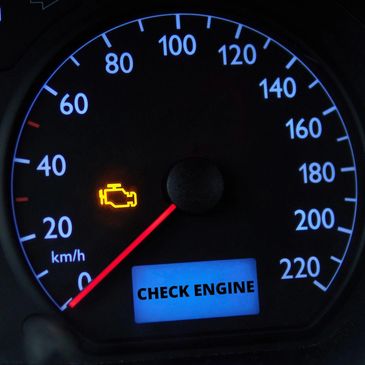 Car dashboard showing a check engine warning light and message.