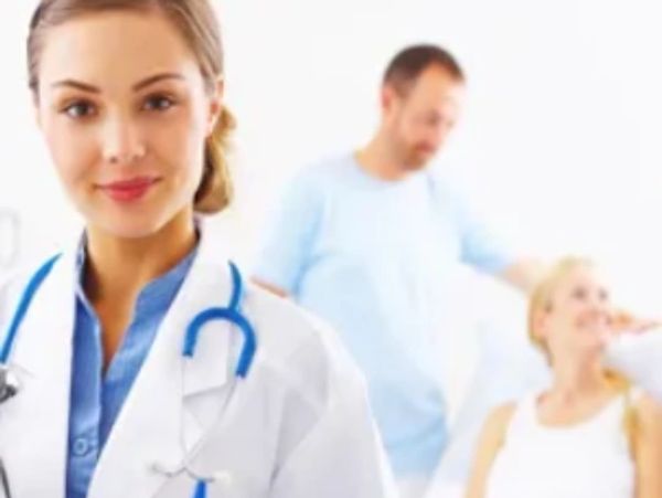 Female doctor with stethoscope and blurred patients.