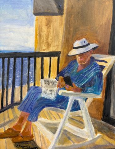 Person in a hat relaxing on a balcony with a phone and newspaper.