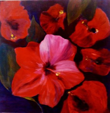 Vibrant red and pink flowers with green leaves on a dark background.