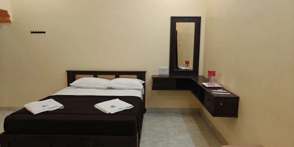 Minimalist bedroom with a double bed and wall-mounted desk.