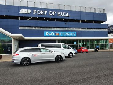 car and mini bus outside Hull ferry terminal King George Dock