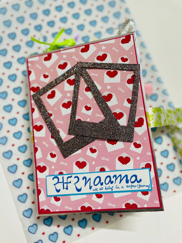 A decorated pink card with glitter frames and hearts, titled 'Safarnaama'.