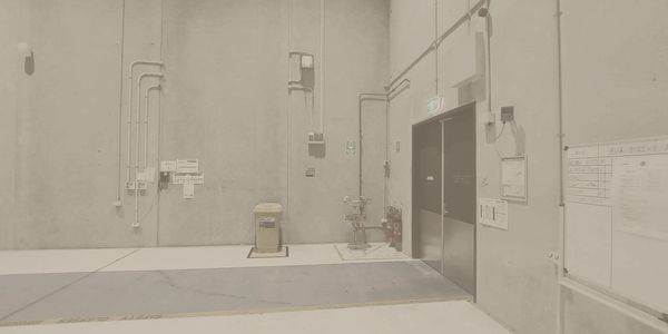 Industrial room with safety equipment and a whiteboard.