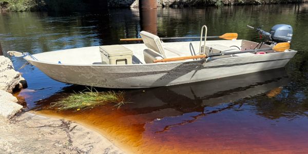 A small motorboat docked near the shore.