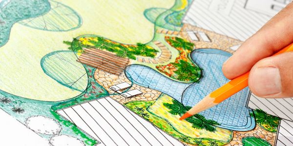 Hand coloring a garden or landscape plan with colored pencils.