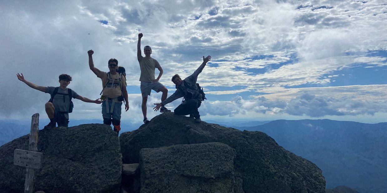 Celebrating a hike in New Hampshire feeling like we are on top of the world!