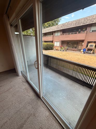 Sliding glass doors open to a small outdoor balcony.