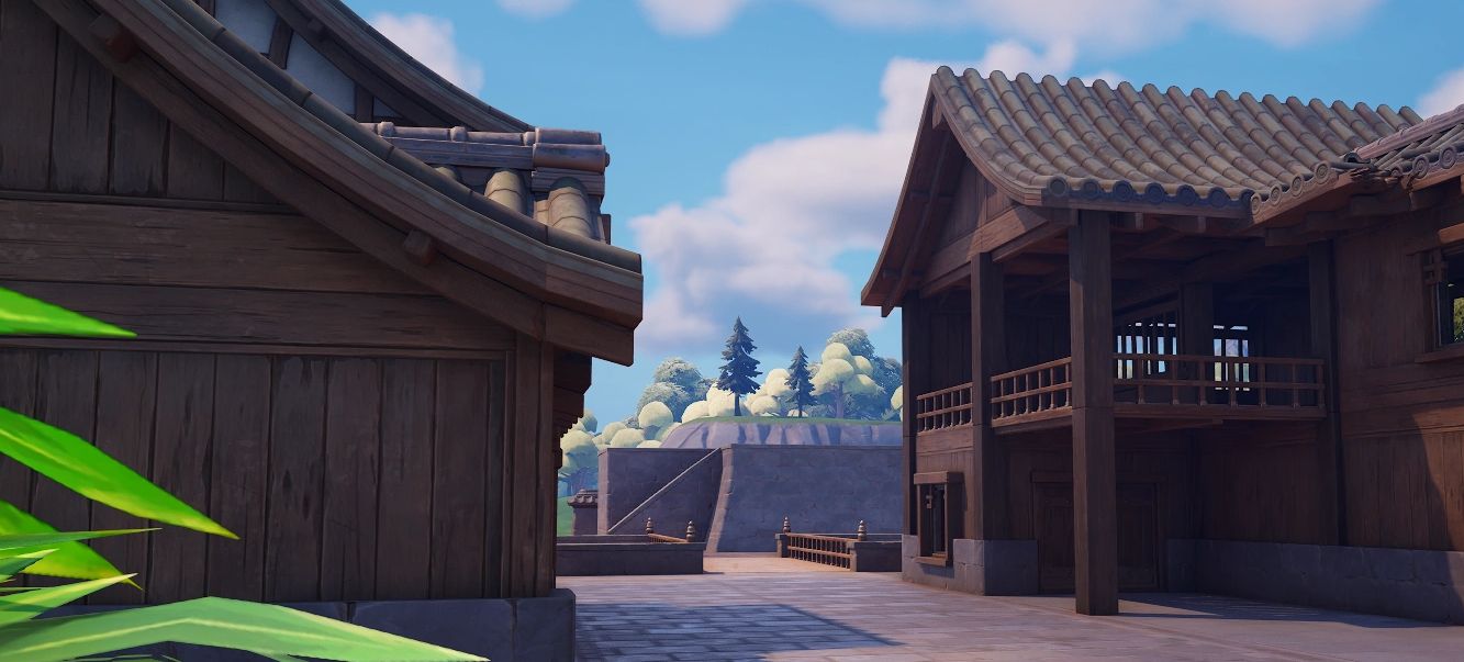 Traditional wooden buildings with tiled roofs under a clear blue sky.