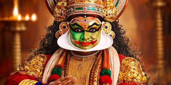 A performer in traditional Kathakali costume and makeup.