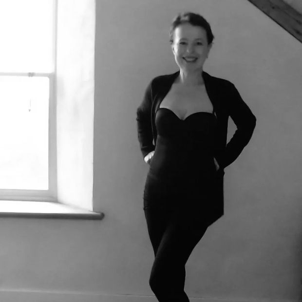 Closeup shot of a woman in black dress smiling