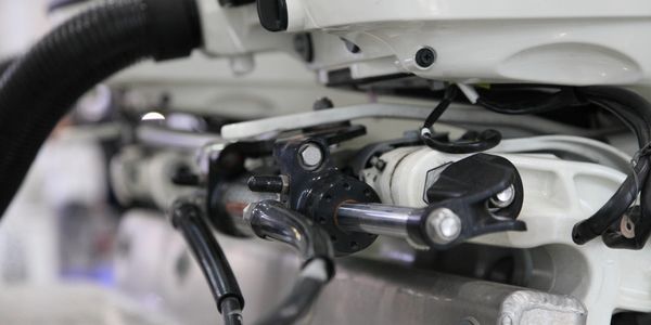 Close-up of hydraulic or mechanical components with cables and metal parts.