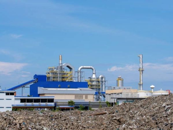 Large industrial plant with white silos.